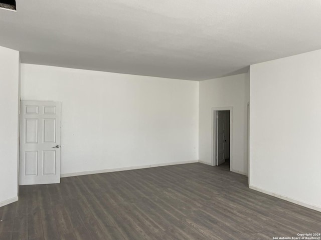 spare room with dark hardwood / wood-style flooring