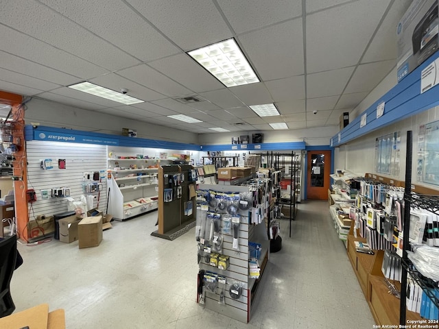 interior space with a paneled ceiling