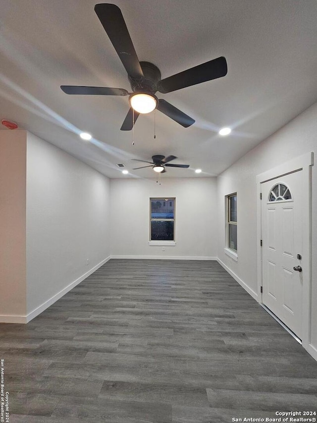 interior space with ceiling fan and dark hardwood / wood-style floors