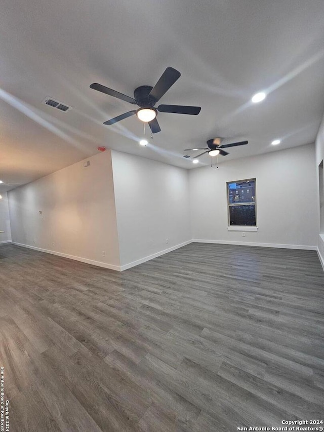 empty room featuring ceiling fan and dark hardwood / wood-style floors