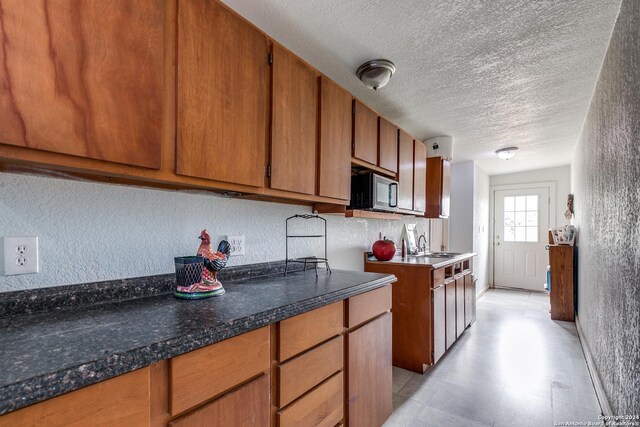 kitchen with a textured ceiling and sink