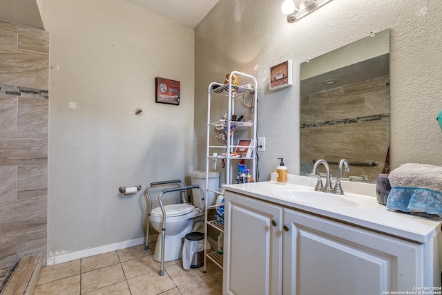 bathroom featuring tile patterned floors, vanity, and toilet