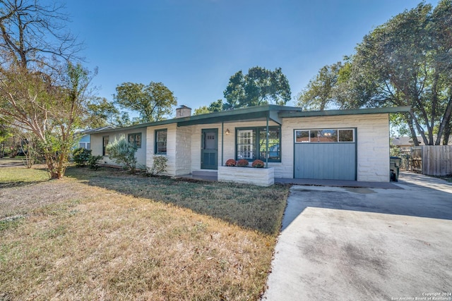 ranch-style home with a porch, a garage, and a front yard