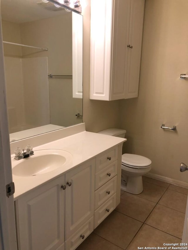 bathroom with tile patterned floors, vanity, and toilet