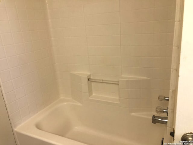 bathroom with bathing tub / shower combination