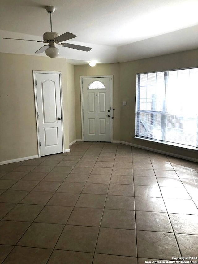 tiled entryway with ceiling fan