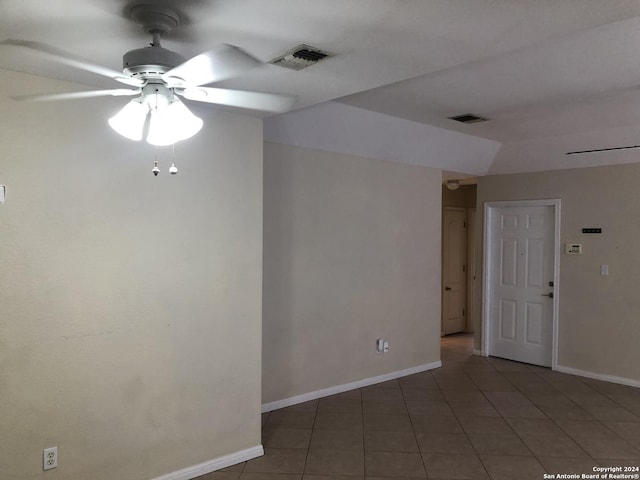 tiled empty room with ceiling fan