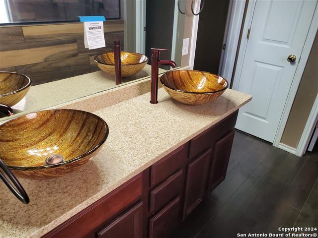 details featuring hardwood / wood-style flooring and sink