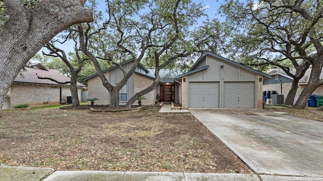 view of front of house featuring cooling unit and a garage