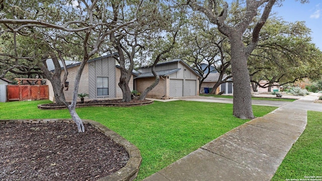 view of front facade with a garage and a front lawn