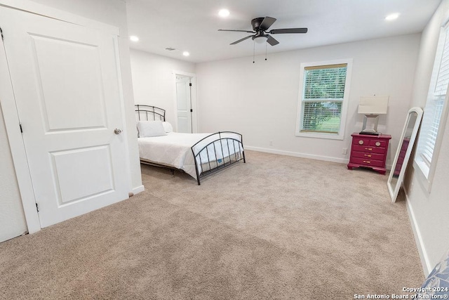 bedroom with light colored carpet and ceiling fan