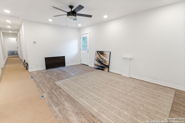 unfurnished living room with ceiling fan and light hardwood / wood-style floors