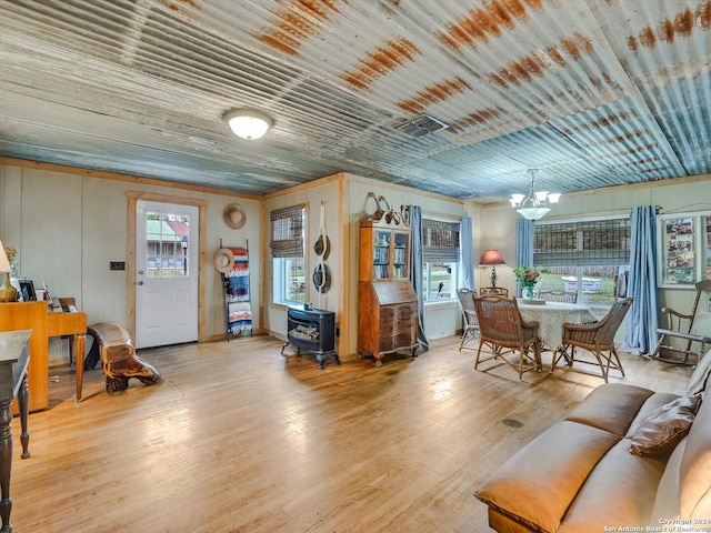 living room featuring light hardwood / wood-style flooring and an inviting chandelier