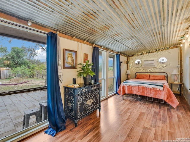 bedroom featuring hardwood / wood-style floors and multiple windows