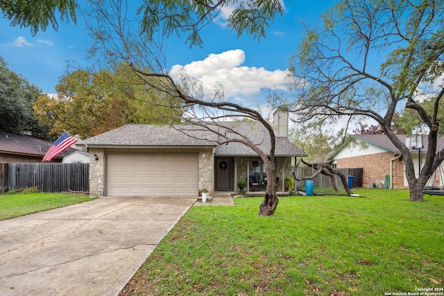 view of front of home with a garage and a front lawn