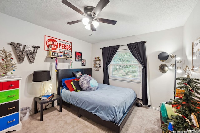 carpeted bedroom featuring ceiling fan and a textured ceiling