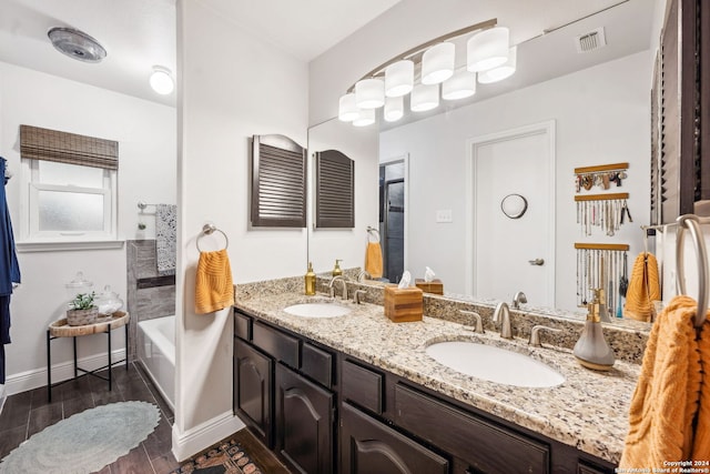 bathroom featuring vanity, hardwood / wood-style flooring, and a bathtub