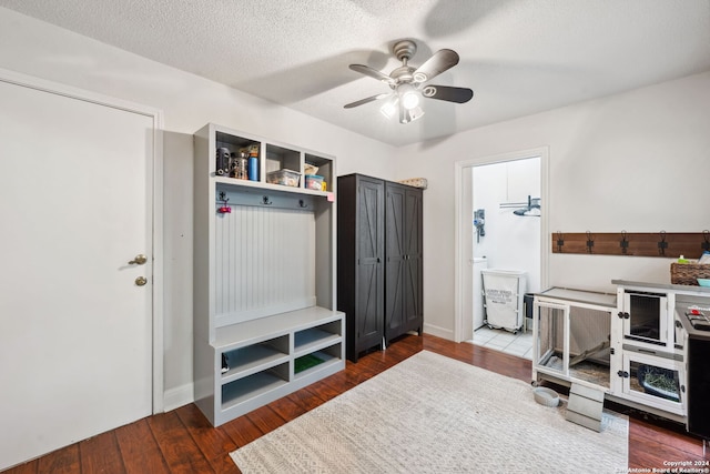 mudroom featuring dark hardwood / wood-style floors, ceiling fan, and a textured ceiling