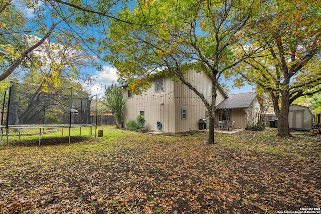 view of yard with a storage shed, a trampoline, and a patio