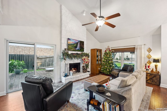 living room with ceiling fan, a fireplace, high vaulted ceiling, and wood-type flooring