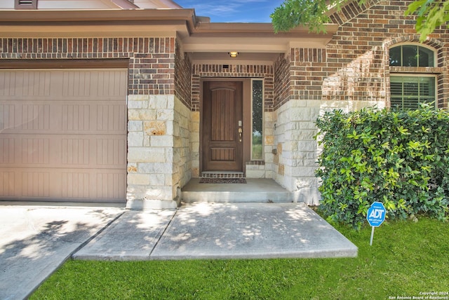 view of exterior entry featuring a garage