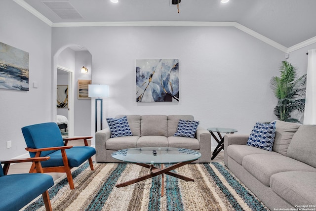 living room featuring crown molding and vaulted ceiling