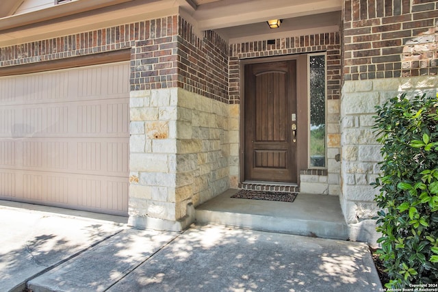 view of exterior entry with a garage