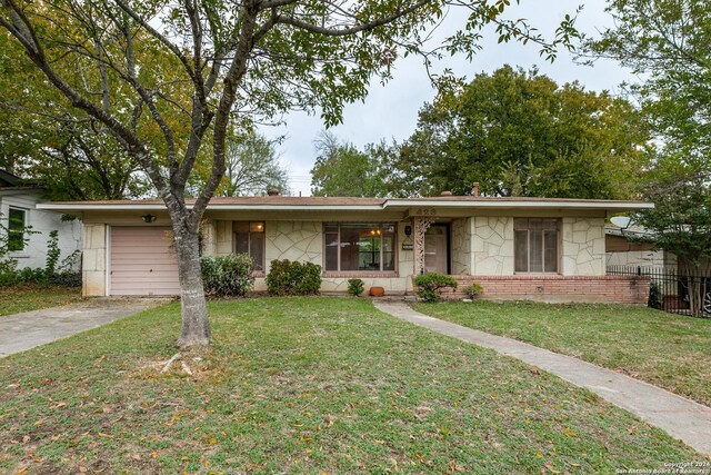 ranch-style home with a front yard and a garage