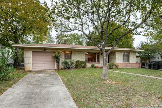 ranch-style home featuring a garage and a front lawn