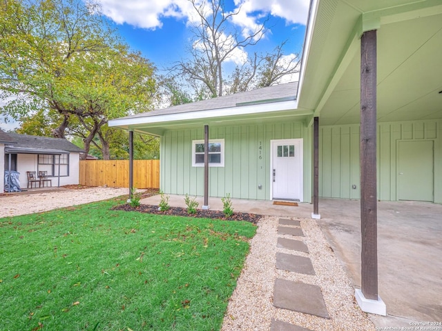 doorway to property featuring a yard