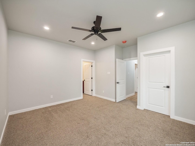 unfurnished bedroom featuring ceiling fan and light carpet