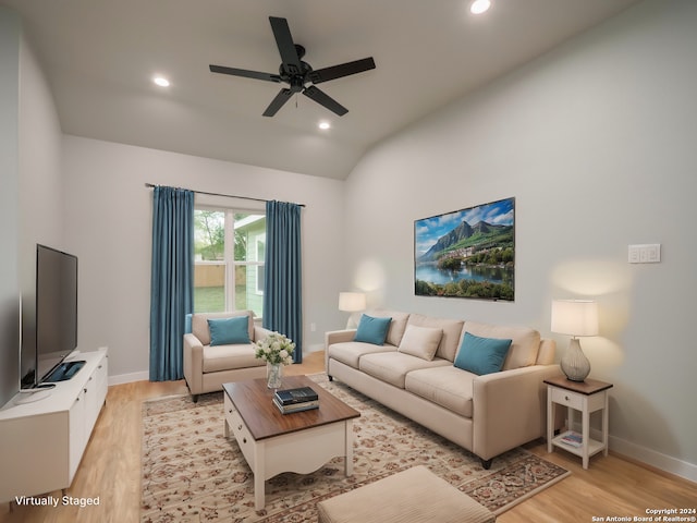 living room featuring ceiling fan, light hardwood / wood-style floors, and lofted ceiling