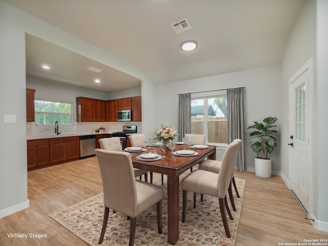 dining room with sink and light hardwood / wood-style floors