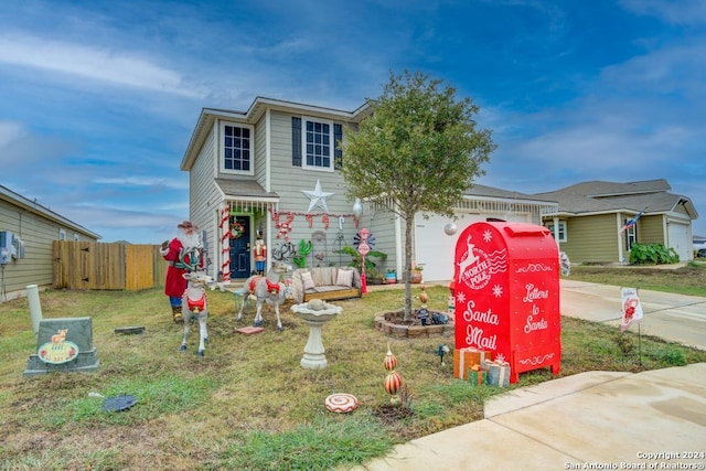 view of front facade with a front yard and a garage