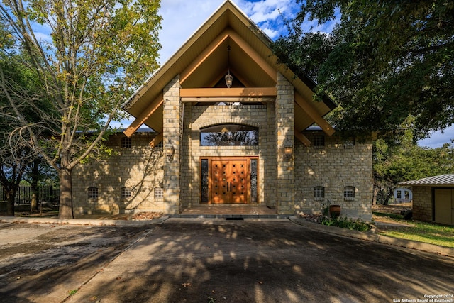 694 Scenic Cir, Pipe Creek, TX 78063 - view of exterior entry featuring stone siding