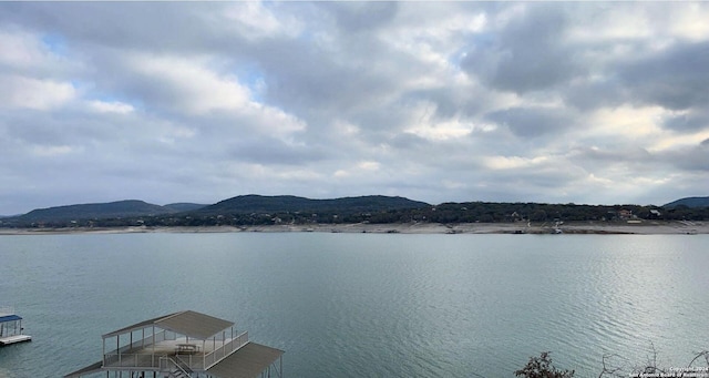 694 Scenic Cir, Pipe Creek, TX 78063 - water view with a dock and a mountain backdrop