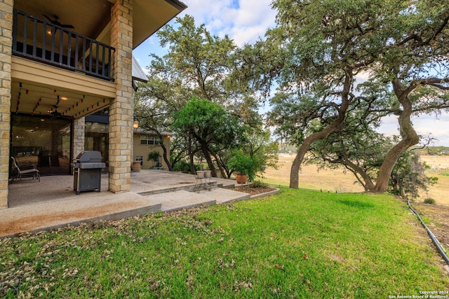 694 Scenic Cir, Pipe Creek, TX 78063 - view of green lawn with a patio and a balcony