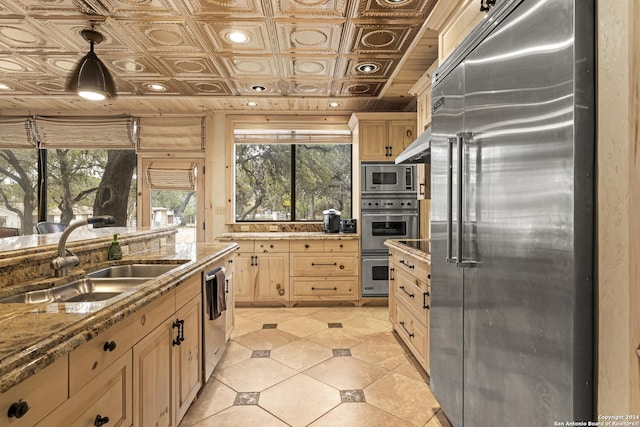 694 Scenic Cir, Pipe Creek, TX 78063 - kitchen featuring stainless steel appliances, light brown cabinets, pendant lighting, light tile patterned flooring, and an ornate ceiling