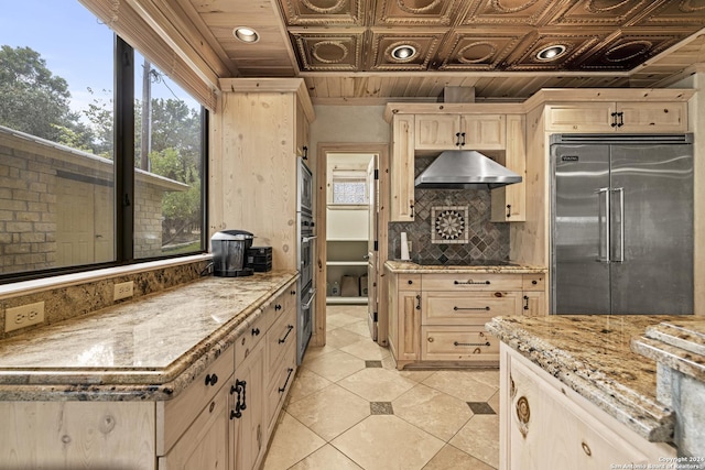 694 Scenic Cir, Pipe Creek, TX 78063 - kitchen with built in appliances, exhaust hood, plenty of natural light, light tile patterned floors, and an ornate ceiling