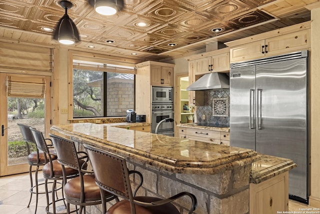 694 Scenic Cir, Pipe Creek, TX 78063 - kitchen with built in appliances, under cabinet range hood, decorative backsplash, an ornate ceiling, and light brown cabinetry