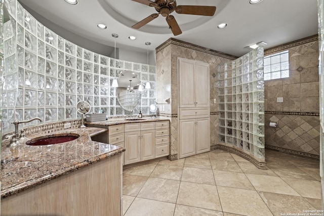 694 Scenic Cir, Pipe Creek, TX 78063 - bathroom with tile walls, two vanities, a ceiling fan, walk in shower, and recessed lighting