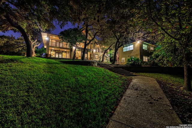 694 Scenic Cir, Pipe Creek, TX 78063 - view of front of property with a balcony, a yard, and stairway