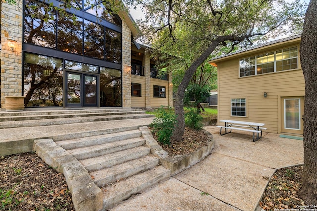 694 Scenic Cir, Pipe Creek, TX 78063 - entrance to property featuring french doors, stone siding, and a patio area