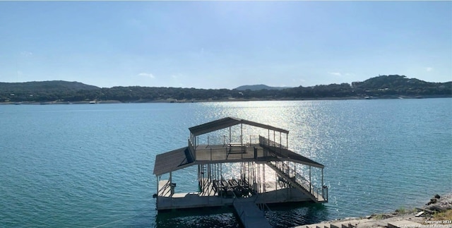 694 Scenic Cir, Pipe Creek, TX 78063 - dock area with a water view and boat lift