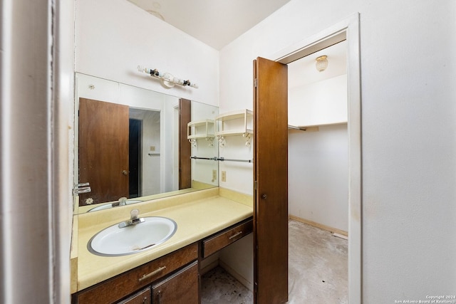 bathroom with concrete flooring and vanity