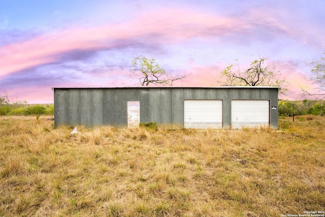 view of garage at dusk