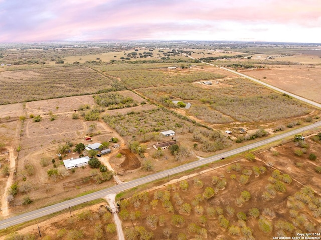 aerial view at dusk featuring a rural view