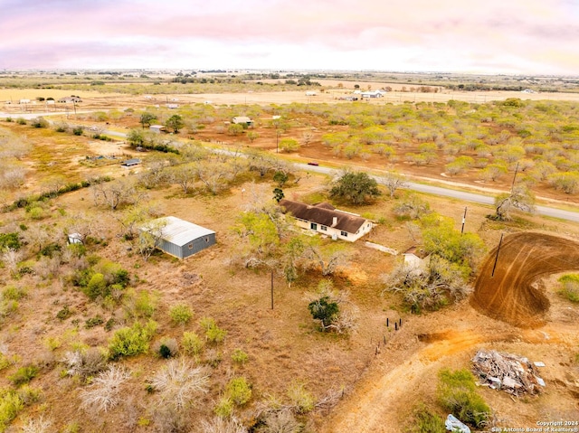 aerial view at dusk featuring a rural view