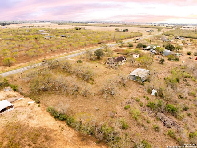 aerial view at dusk featuring a rural view