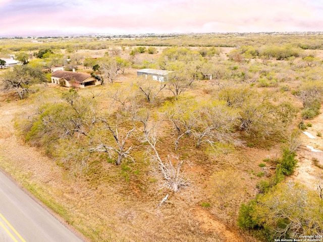 aerial view at dusk featuring a rural view